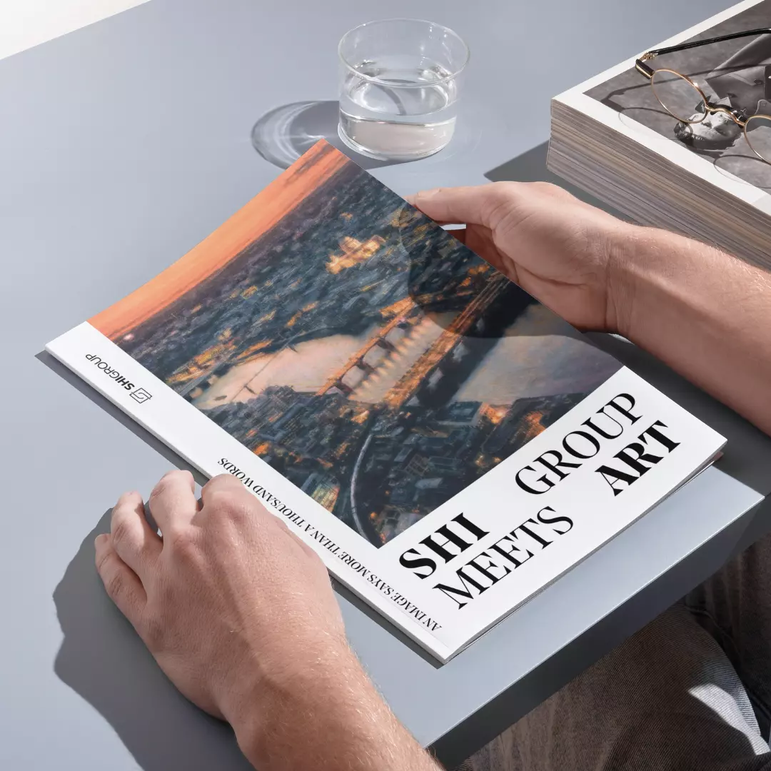 Ein Mann hält eine Zeitschrift der GKV auf einem Tisch mit Blick auf eine Stadt.